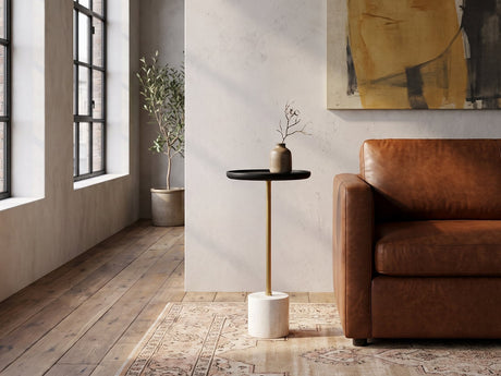 Calimera Black Mango and Marble Pedestal Side Table beside a leather sofa in an industrial loft