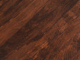 Close-up of the Camaiore Faceted Mango Drum Coffee Table: the walnut brown mango figure of the round top