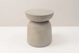 The Cammarata light grey concrete dish-top bell side table, three-quarter view on a light studio backdrop
