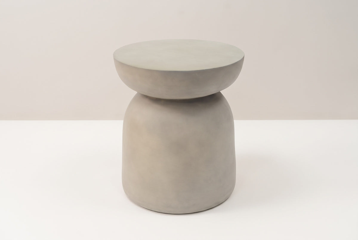 The Cammarata light grey concrete dish-top bell side table, three-quarter view on a light studio backdrop