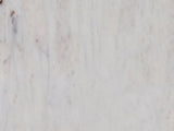 Close-up of the Camogli Marble and Black Metal Drum Side Table: the soft grey veining of the white marble top