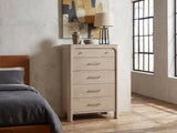 Caorle 38-Inch Weathered Mango 5-Drawer Chest against a plaster wall in an industrial loft bedroom