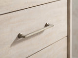 Close-up of the Caorle 38-Inch Weathered Mango 5-Drawer Chest: an antique-brass bar pull on the weathered mango drawer front