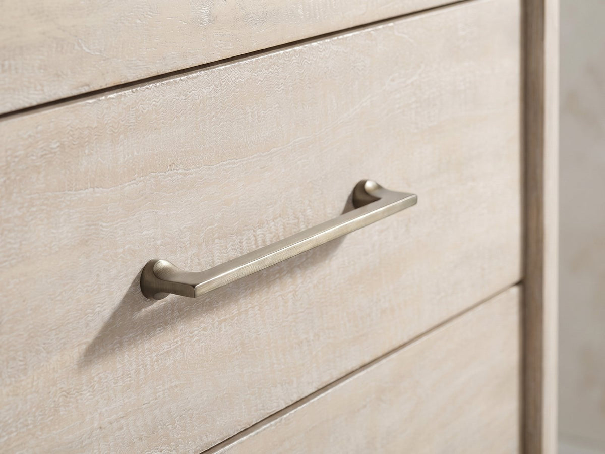 Close-up of the Caorle 38-Inch Weathered Mango 5-Drawer Chest: an antique-brass bar pull on the weathered mango drawer front