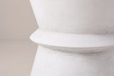 Close-up of the antique white lightweight concrete on the Capizzi side table, with faint brush marks around the waist ring