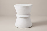 The Capizzi antique white concrete hourglass side table, three-quarter view on a light studio backdrop