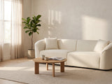 Capri Curved Boucle Sofa in a furnished room