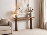 Capurso Wood Veneer Trestle Console Table against a plaster wall under an abstract canvas in a bright living room
