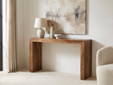 Carosino Solid Sheesham Waterfall Console Table against a plaster wall under an abstract canvas in a bright living room