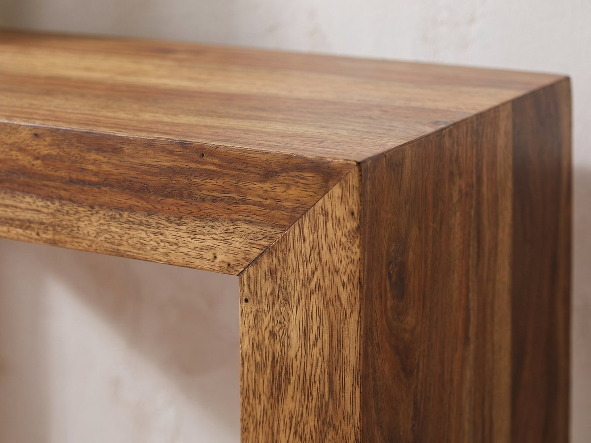 Close-up of the Carosino Solid Sheesham Waterfall Console Table: the mitred corner where the thick sheesham top meets an end panel