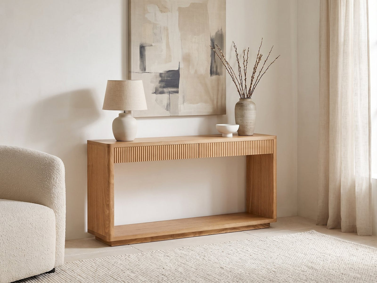 Carovigno Fluted Wood Veneer Console Table against a plaster wall under an abstract canvas in a bright living room