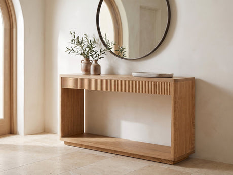 Carovigno Fluted Wood Veneer Console Table under a round mirror in a travertine entryway