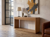Carovigno Fluted Wood Veneer Console Table against a plaster wall in an industrial loft