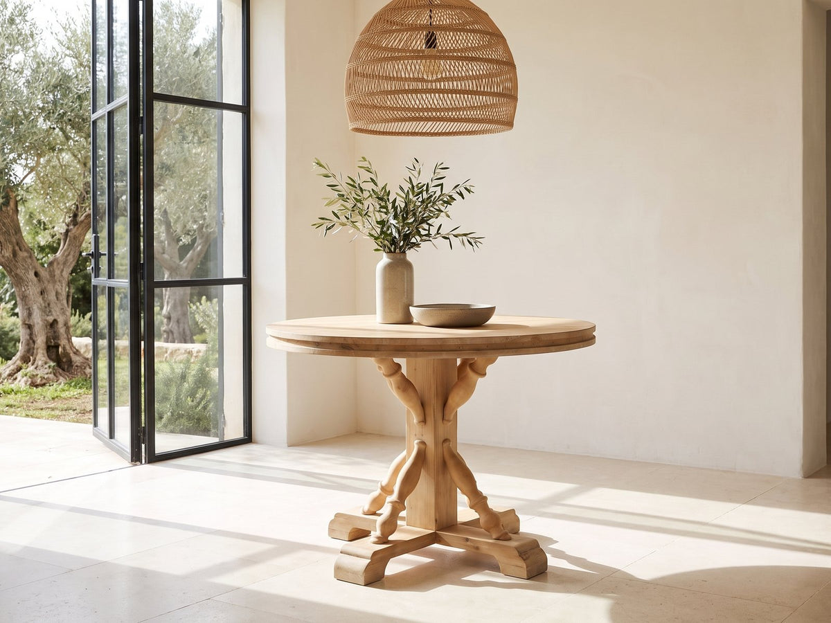 Casabona 42-Inch Round Fir Baluster Pedestal Dining Table in a sunlit villa dining area with olive trees outside