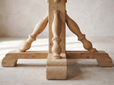 Close-up of the Casabona 42-Inch Round Fir Baluster Pedestal Dining Table: the square fir post with its turned baluster braces and stepped bracket feet