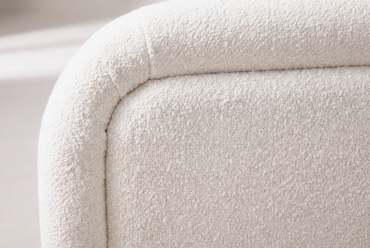 Close-up of the white boucle on the Casacalenda bed: small curly loops at the rolled edge of the headboard border