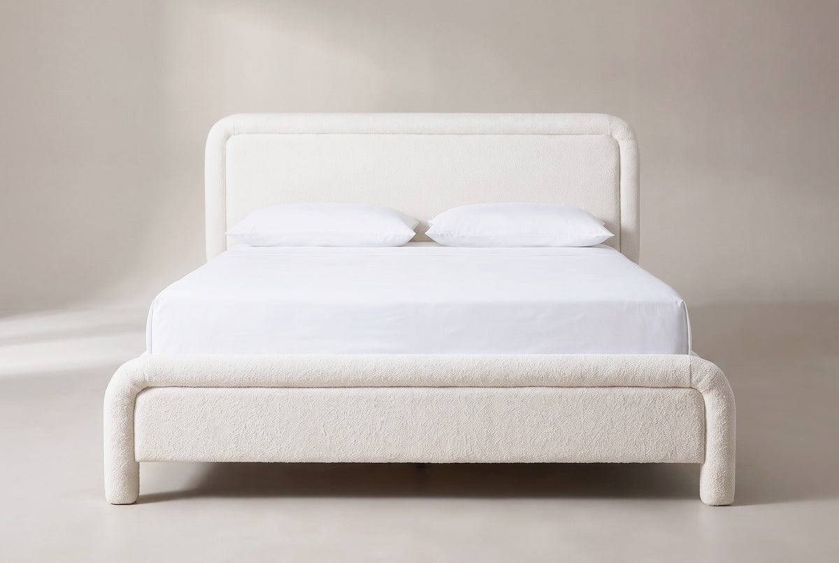 Casacalenda bed in white boucle with a white mattress and pillows (not included), front view