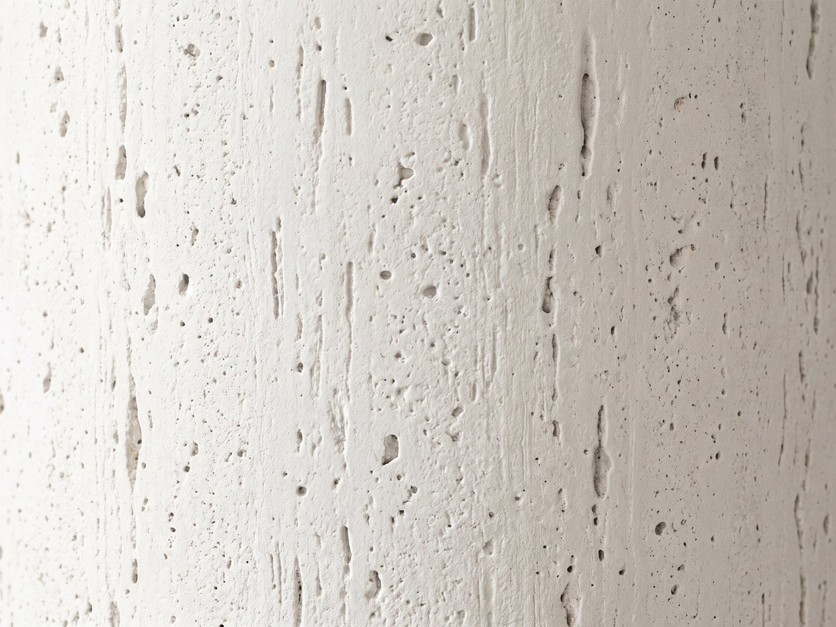 Close-up of the Casarano Fiber Concrete Hourglass Side Table: the travertine-like cast texture of the column