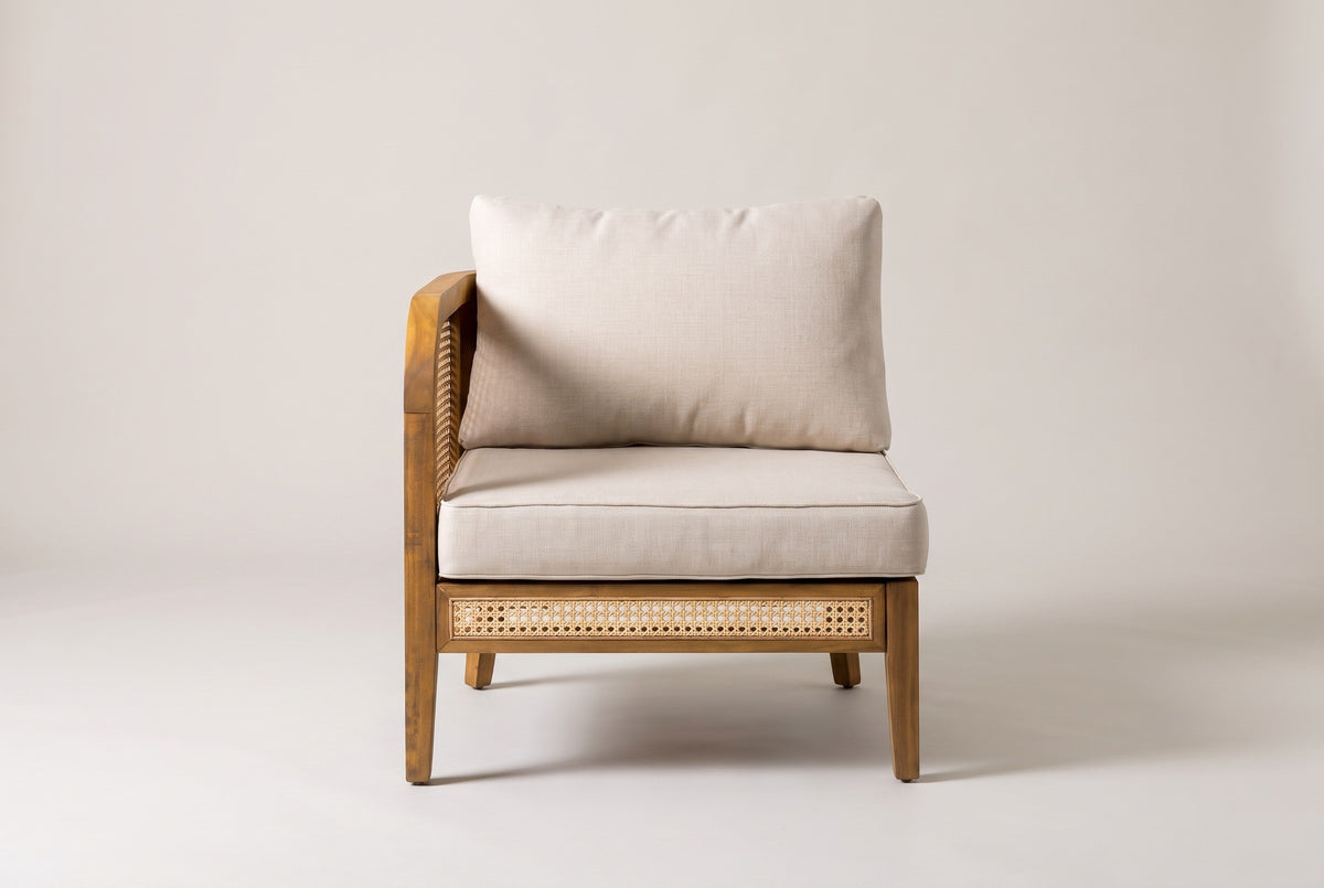 The Castelbuono left arm chair seen straight from the front: the arm on the left, the open right side and the cane panel in the front rail