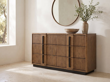 Castelfranco 65.5-Inch Ash Brown Reeded 6-Drawer Dresser under a round bronze mirror in a villa bedroom
