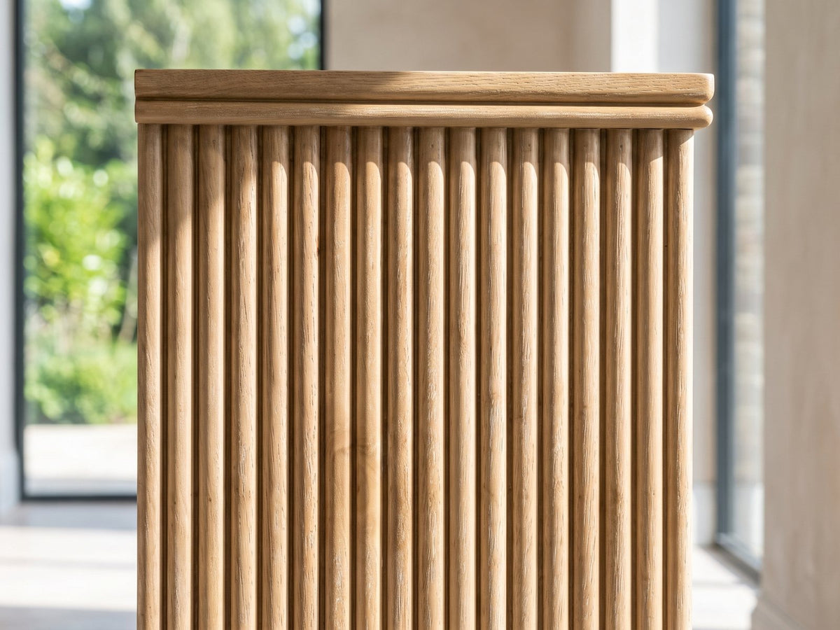 Close-up of the Cefalu Fluted Oak Media Console: the fluted end panel of the console: rows of vertical half-round oak flutes under the top