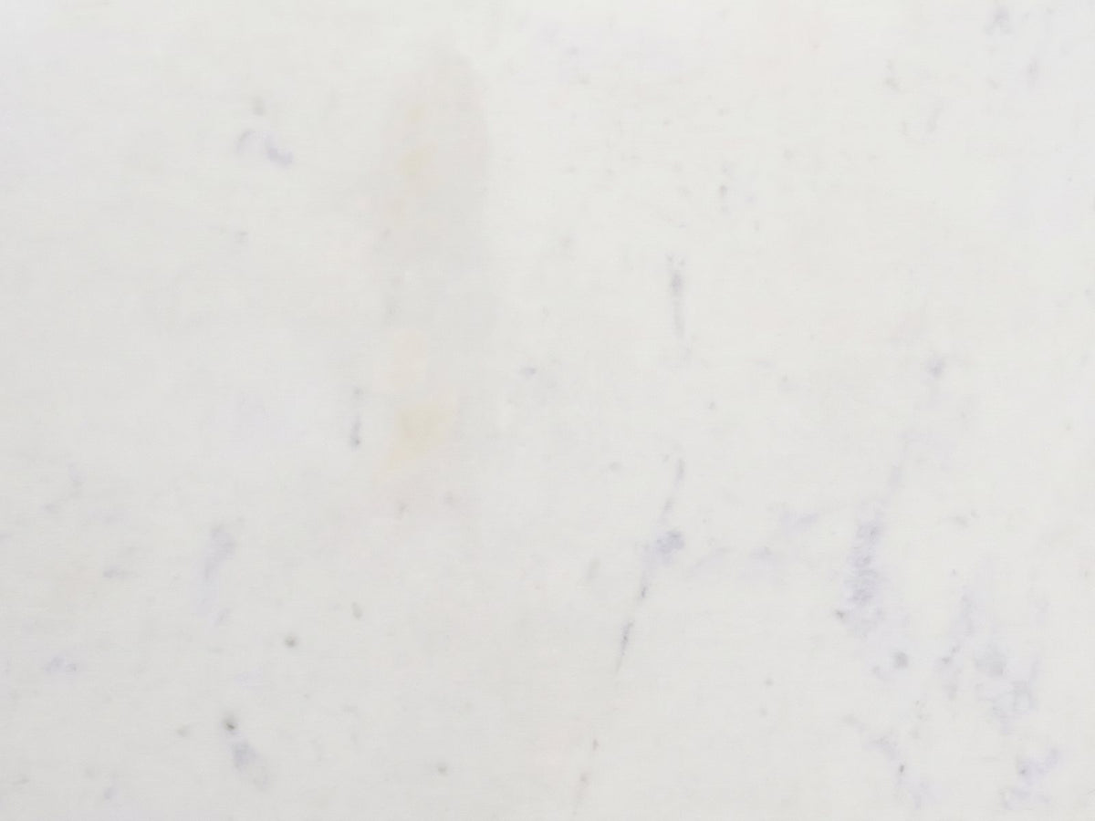 Close-up of the Ceglie White Marble Hourglass Side Table: the white Banswara marble of the top