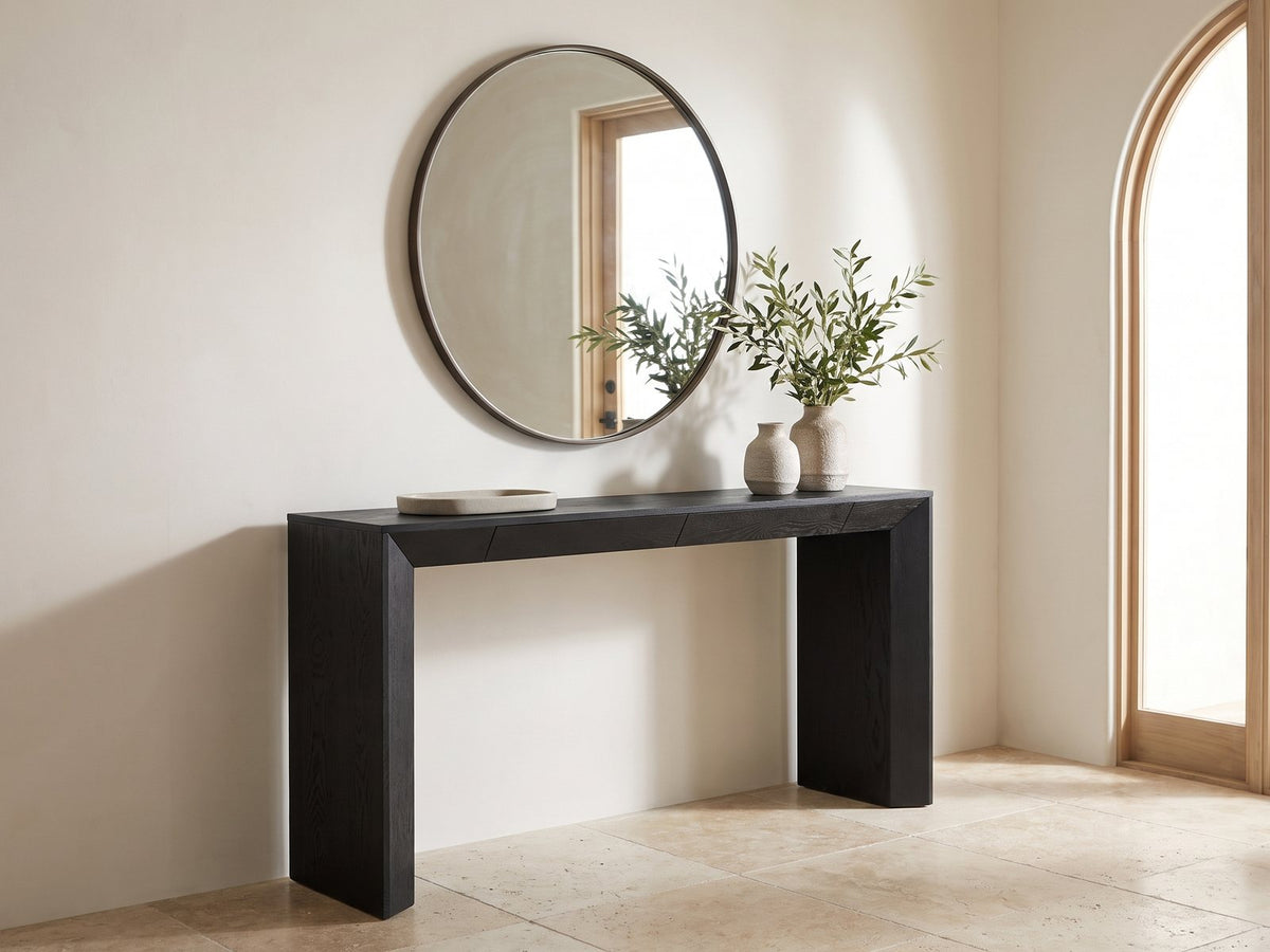 Cellamare Black Ash Veneer Waterfall Console Table under a round mirror in a travertine entryway