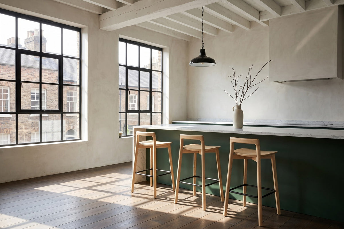 Cervicati 26.5-Inch Solid Ash Low-Back Counter Stool in a city loft