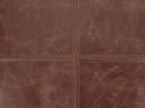 Close-up of the Cervo Distressed Brown Genuine Leather Square Pouf: the four-panel top, its two topstitched seams crossing at the centre