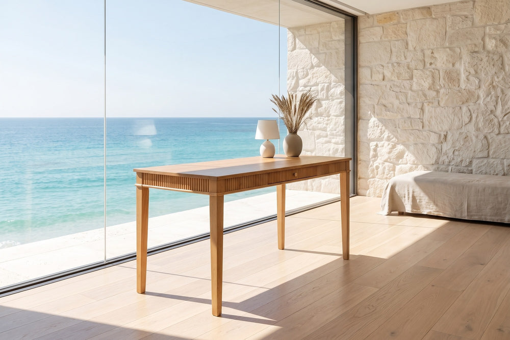 Cessaniti 63-Inch 1-Drawer Reeded Rubberwood Writing Desk in an oceanfront glass house