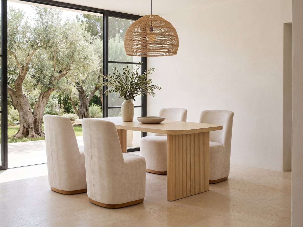 Cetraro 68.75-Inch Fluted Leg Dining Set with 4 Upholstered Chairs in a sunlit villa dining area with olive trees outside