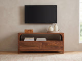 Cherasco Arch Mango Media Console styled with a box, a tray of vases and books under a wall-mounted screen
