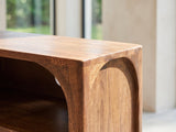 Close-up of the Cherasco Arch Mango Media Console: the rounded top corner of the arch in solid mango, the grain wrapping the curve