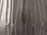 Close-up of the Chianciano Cast Aluminum Faceted Drum Side Table: the faceted graphite cast aluminum wall