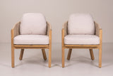 The two Chiaramonte dining armchairs seen from the front: straight acacia front posts, light beige seat cushions on the acacia seat frame and back cushions above the rope