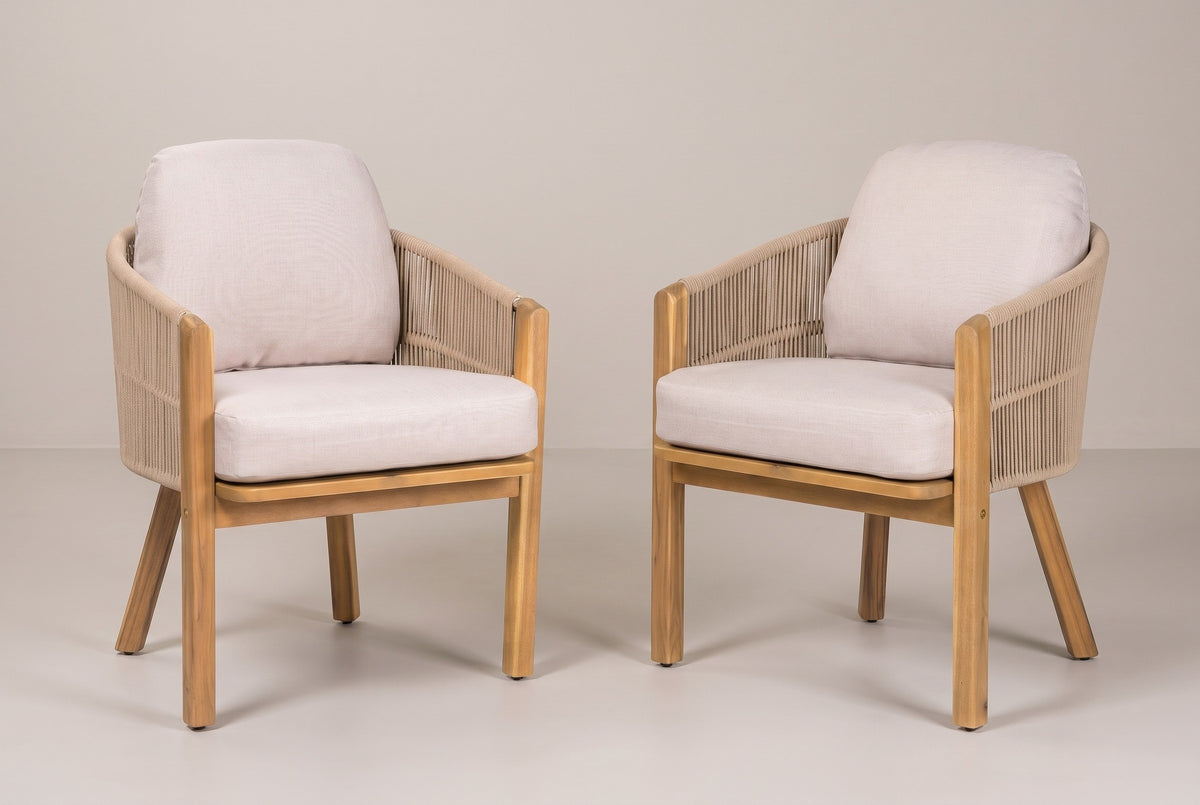 The set of two Chiaramonte acacia and rope outdoor dining armchairs with light beige cushions, three-quarter view on a light studio backdrop
