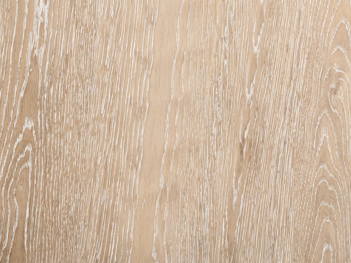 Close-up of the Chiavari Oak Veneer Round Pedestal Coffee Table: the limed oak veneer grain of the top