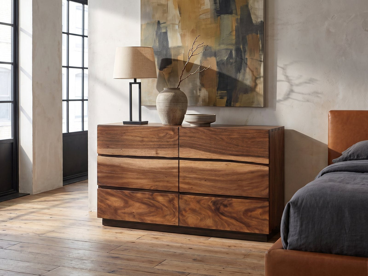 Chioggia 64-Inch Smokey Walnut 6-Drawer Dresser against a plaster wall in an industrial loft bedroom