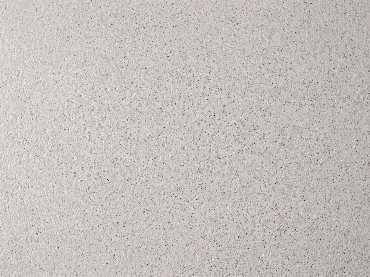 Close-up of the Cilento Grey Fiberglass Pebble Coffee Table and Side Table Set: the speckled matte finish of the fiberglass