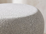 Close-up of the Cilento Speckled Grey Fiberglass Pebble Side Table: the rounded shoulder where the top rolls into the side