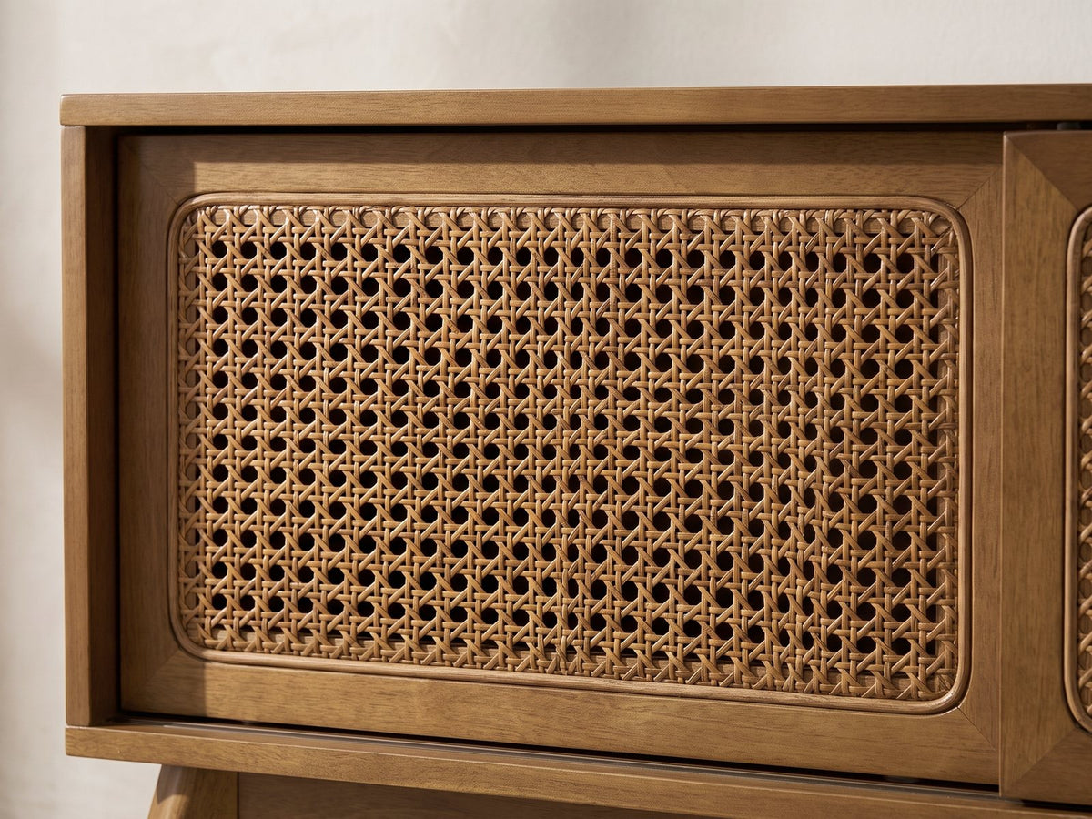 Close-up of the Cisternino 59-Inch Pecan Birch Veneer and Cane Media Console: a sliding door's natural woven cane panel in its mitred wooden frame