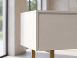 Close-up of the Cittadella White Media Console: the top corner of the white console with its subtle wood grain and the brass leg below