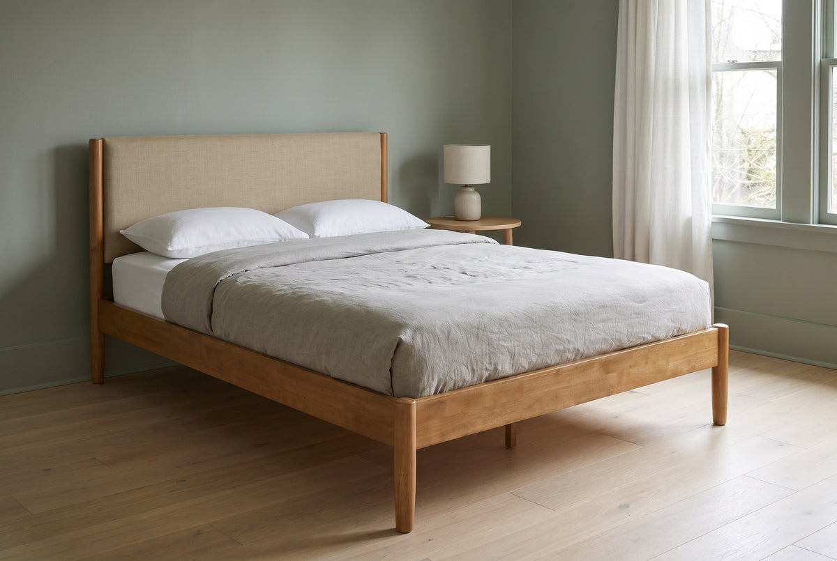 Civitella bed against a sage green wall in a Portland craftsman bedroom with a pale oak floor and a round white-oak side table