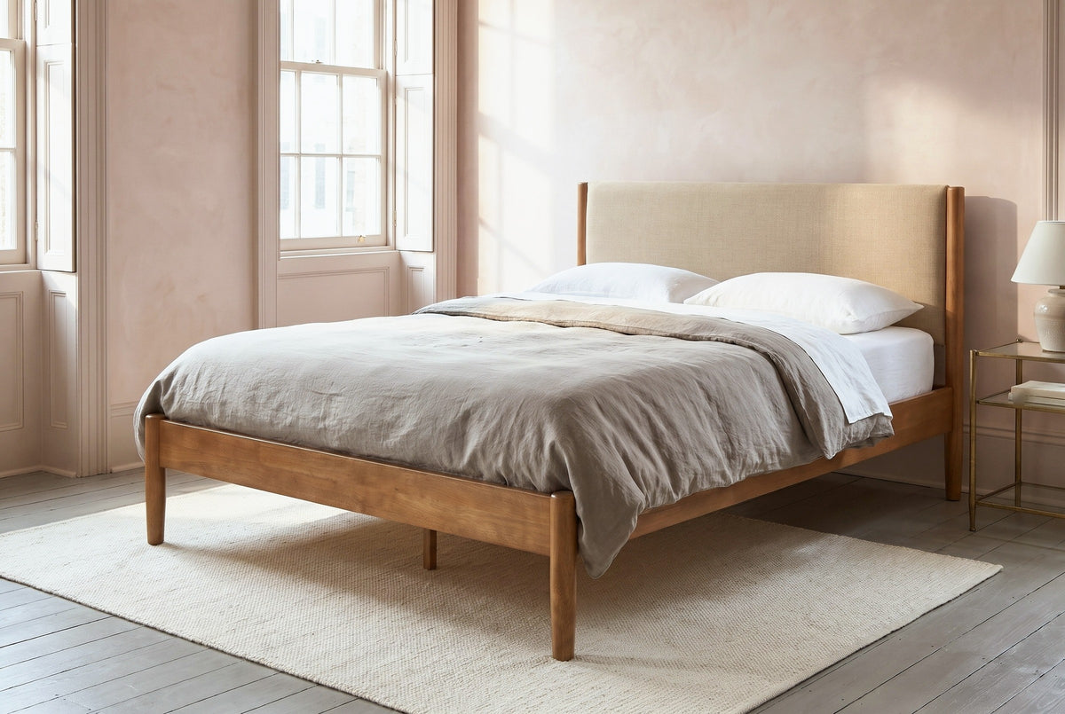 Civitella bed against a blush plaster wall in a Savannah townhouse bedroom with tall shuttered windows and a cream rug
