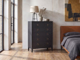 Cologna 40-Inch Peppercorn 5-Drawer Chest against a plaster wall in an industrial loft bedroom
