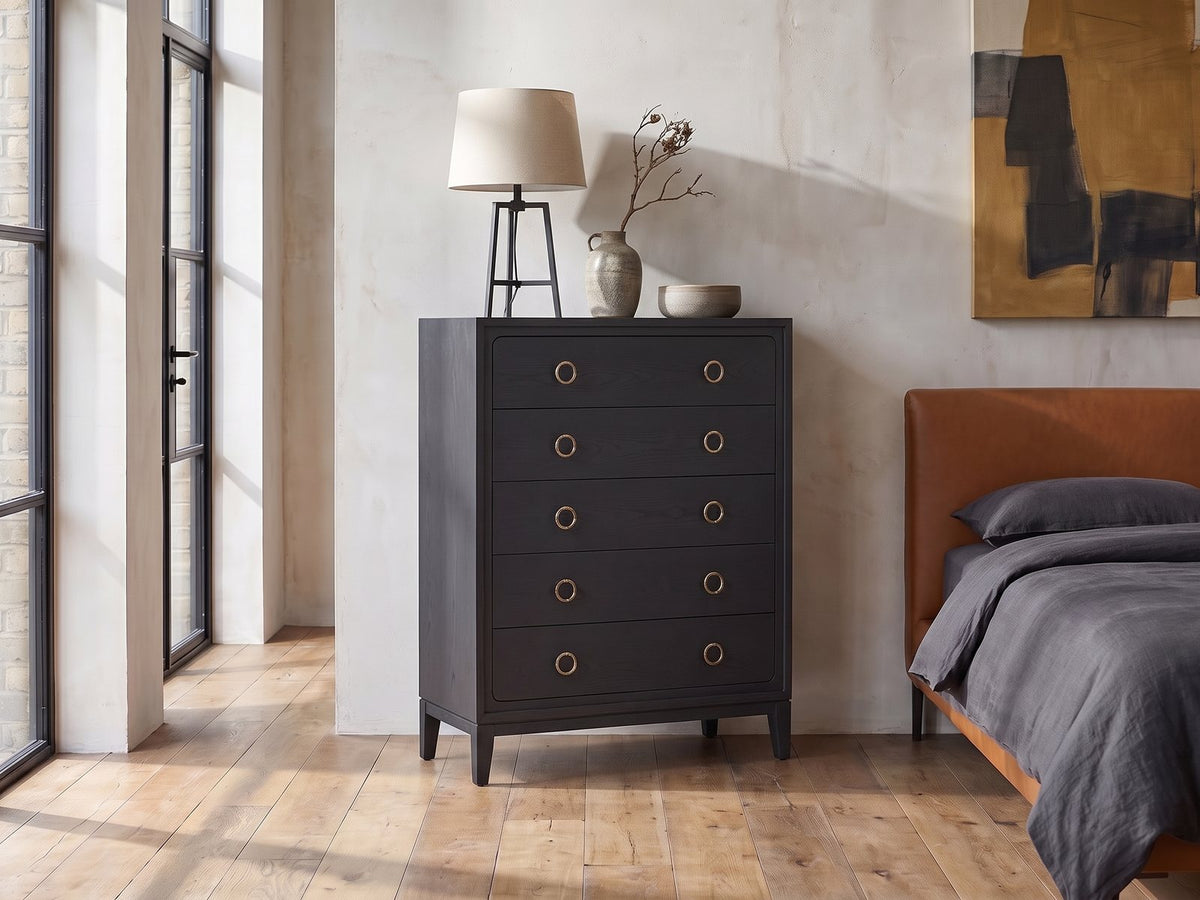 Cologna 40-Inch Peppercorn 5-Drawer Chest against a plaster wall in an industrial loft bedroom