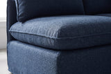 Close-up of the textured navy fabric on a Comiso seat: the piped cushion edge over the slipcovered base