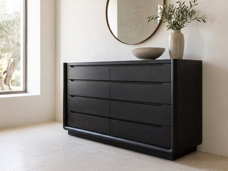 Conegliano 66-Inch Burnished Black 8-Drawer Dresser under a round bronze mirror in a villa bedroom