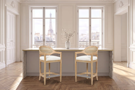 Conflenti 26-Inch Cane-Back Oak Counter Stool, Ivory Boucle in a Paris salon