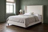 Conversano bed against a deep sage green plaster wall in a Boston brownstone bedroom with dark oak floors and a sash window